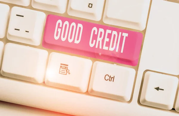 Writing note showing Good Credit. Business photo showcasing borrower has a relatively high credit score and safe credit risk White pc keyboard with note paper above the white background.