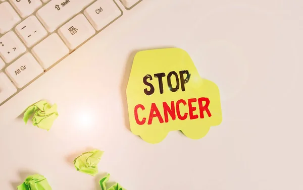 Handwriting text writing Stop Cancer. Concept meaning prevent the uncontrolled growth of abnormal cells in the body Green note paper in the shape of the car. Copy space on the green note paper. — Stock Photo, Image