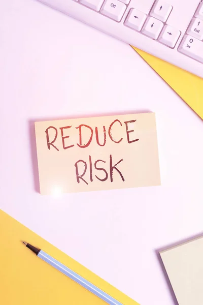 Text sign showing Reduce Risk. Conceptual photo lessen the potential damage that could be caused by a hazard Flat lay above table with pc keyboard and copy space paper for text messages. — Stock Photo, Image