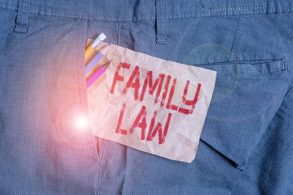 Word writing text Family Law. Business concept for the branch of law that deals with matters relating to the family Writing equipment and brown note paper inside pocket of man work trousers.