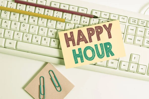 Conceptual hand writing showing Happy Hour. Business photo showcasing when drinks are sold at reduced prices in a bar or restaurant White keyboard with note paper and clips on white background. — 图库照片