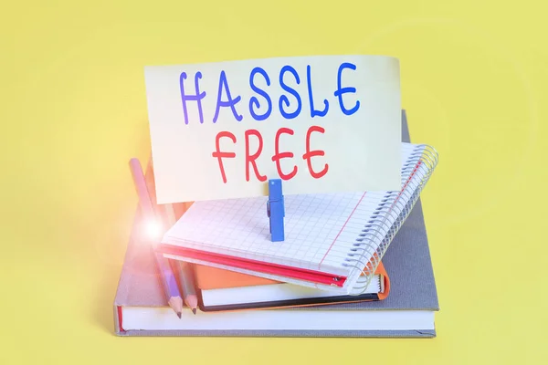 Conceptual hand writing showing Hassle Free. Business photo showcasing Without having a difficult situation or problem to dealt with Book pencil rectangle shaped reminder notebook clothespins. — Stock Photo, Image