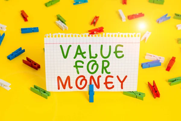 Handwriting text Value For Money. Concept meaning reference to something is well worth the money spent on it Colored clothespin papers empty reminder yellow floor background office.