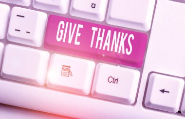 Writing note showing Give Thanks. Business photo showcasing express gratitude or show appreciation Acknowledge the kindness White pc keyboard with note paper above the white background.