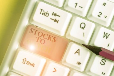 Conceptual hand writing showing Stocks To Watch. Business photo showcasing being heavy broker and watch every increase decrease White pc keyboard with note paper above the white background.