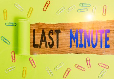 Text sign showing Last Minute. Conceptual photo done or occurring at the latest possible time before an event Paper clip and torn cardboard placed above a wooden classic table backdrop.