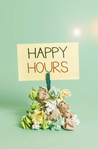 Word writing text Happy Hours. Business concept for when drinks are sold at reduced prices in a bar or restaurant Reminder pile colored crumpled paper clothespin reminder blue background. — Stock Photo, Image