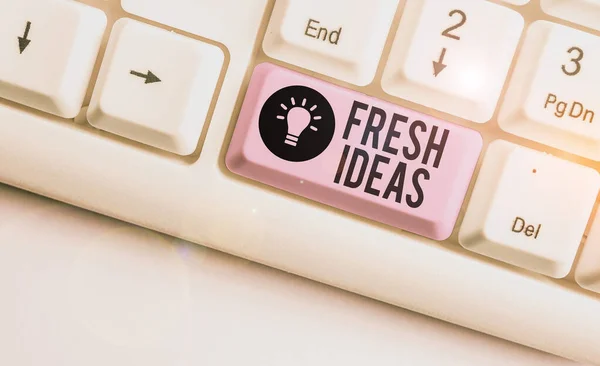 Text sign showing Fresh Ideas. Conceptual photo the thought or suggestion as to possible course of action White pc keyboard with empty note paper above white background key copy space. — Stock Photo, Image