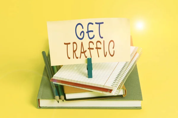 Conceptual hand writing showing Get Traffic. Business photo showcasing amount of data sent and received by visitors to a website Book pencil rectangle shaped reminder notebook clothespins.