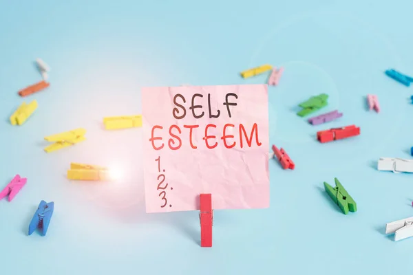 Handwriting text Self Esteem. Concept meaning a feeling of having respect for yourself and your abilities Colored clothespin rectangle square shaped paper light blue background.