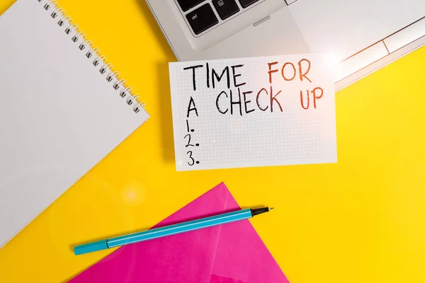 Conceptual hand writing showing Time For A Check Up. Business photo showcasing a Thorough Examination have a Look on something someone Laptop marker square sheet spiral notebook color background.