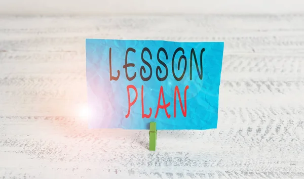 Word writing text Lesson Plan. Business concept for a teacher s is detailed description of the course of instruction Green clothespin white wood background colored paper reminder office supply.