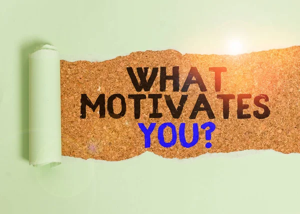 Writing note showing What Motivates Youquestion. Business photo showcasing know reasons why you want to wake up each morning Cardboard which is torn placed above a wooden classic table. — Stock Photo, Image