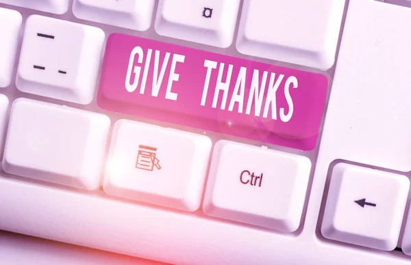 Writing note showing Give Thanks. Business photo showcasing express gratitude or show appreciation Acknowledge the kindness White pc keyboard with note paper above the white background.
