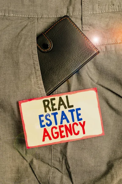 Conceptual hand writing showing Real Estate Agency. Business photo showcasing Business Entity Arrange Sell Rent Lease Manage Properties Small wallet inside trouser front pocket near notation paper. — Stock Photo, Image