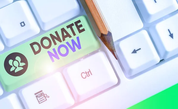 Kata menulis teks Donate Now. Konsep bisnis untuk memberikan sesuatu seperti uang atau barang untuk amal atau alasan apapun . — Stok Foto