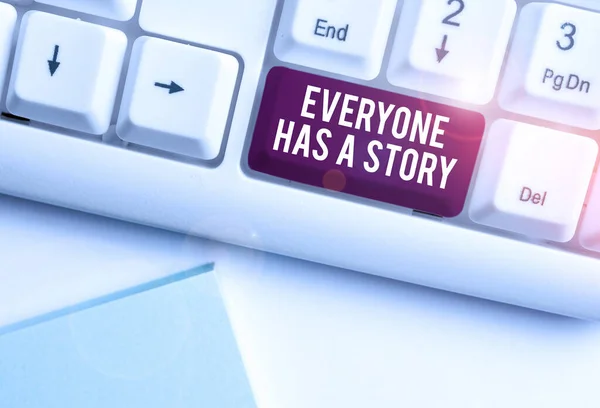 Text sign showing Everyone Has A Story. Conceptual photo Background storytelling telling your memories tales White pc keyboard with empty note paper above white background key copy space. — Stockfoto
