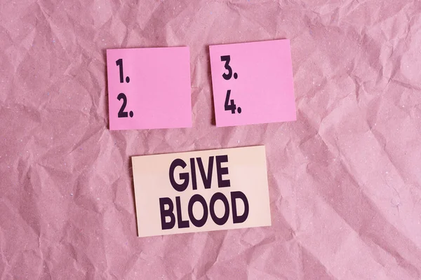 単語の執筆テキスト血を与えなさい。自発的に実証するためのビジネスの概念は、輸血のために血が描かれ、使用されています紙工芸紙机角スパイラルノートブックオフィス研究用品. — ストック写真