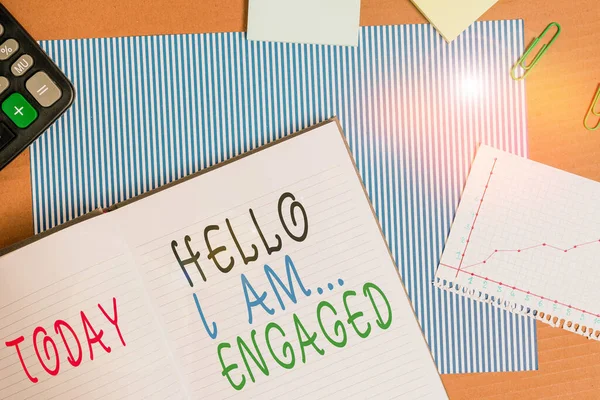 Handwriting text writing Hello I Am Engaged. Concept meaning He gave the ring We are going to get married Wedding Striped paperboard notebook cardboard office study supplies chart paper.