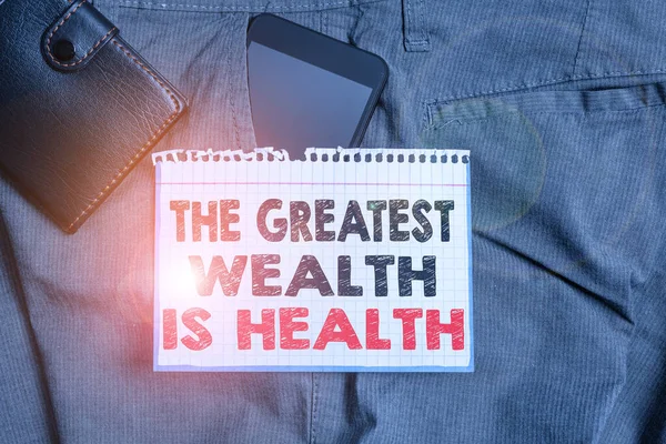 Writing note showing The Greatest Wealth Is Health. Business photo showcasing Many sacrifice their money just to be healthy Smartphone device inside trousers front pocket with wallet. — Stok fotoğraf