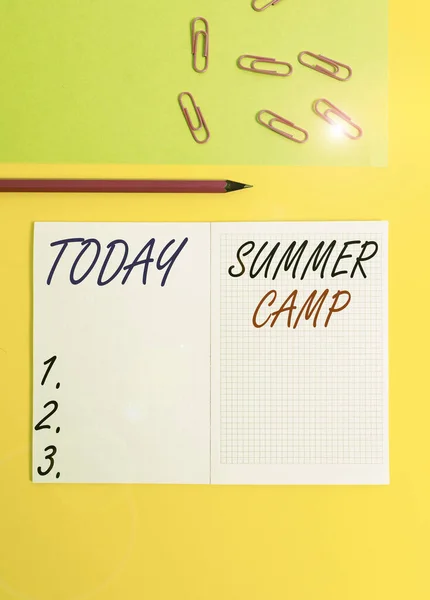 Handwriting text writing Summer Camp. Concept meaning supervised program for children conducted during the summer Blank squared notebook pencil marker paper sheet plain colored background. — ストック写真
