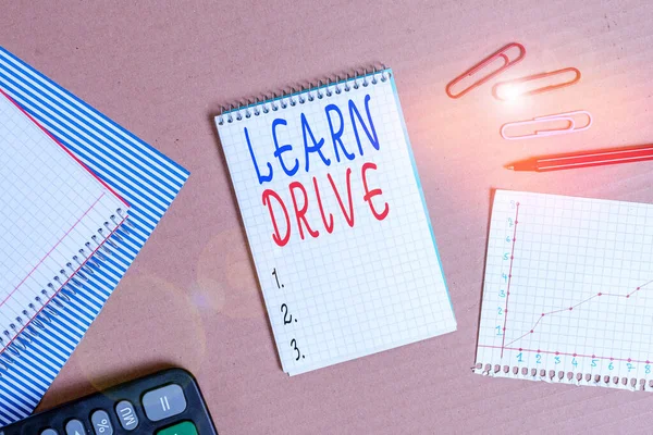 Handwriting text writing Learn Drive. Concept meaning to gain the knowledge or skill in driving a motor vehicle Striped paperboard notebook cardboard office study supplies chart paper. — Stock Photo, Image