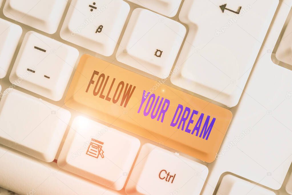 Text sign showing Follow Your Dream. Conceptual photo Keep track on your goals Live the life you want to be White pc keyboard with empty note paper above white background key copy space.