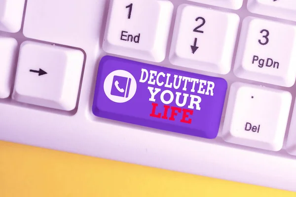 Writing note showing Declutter Your Life. Business photo showcasing To eliminate extraneous things or information in life White pc keyboard with note paper above the white background. — Stock Photo, Image