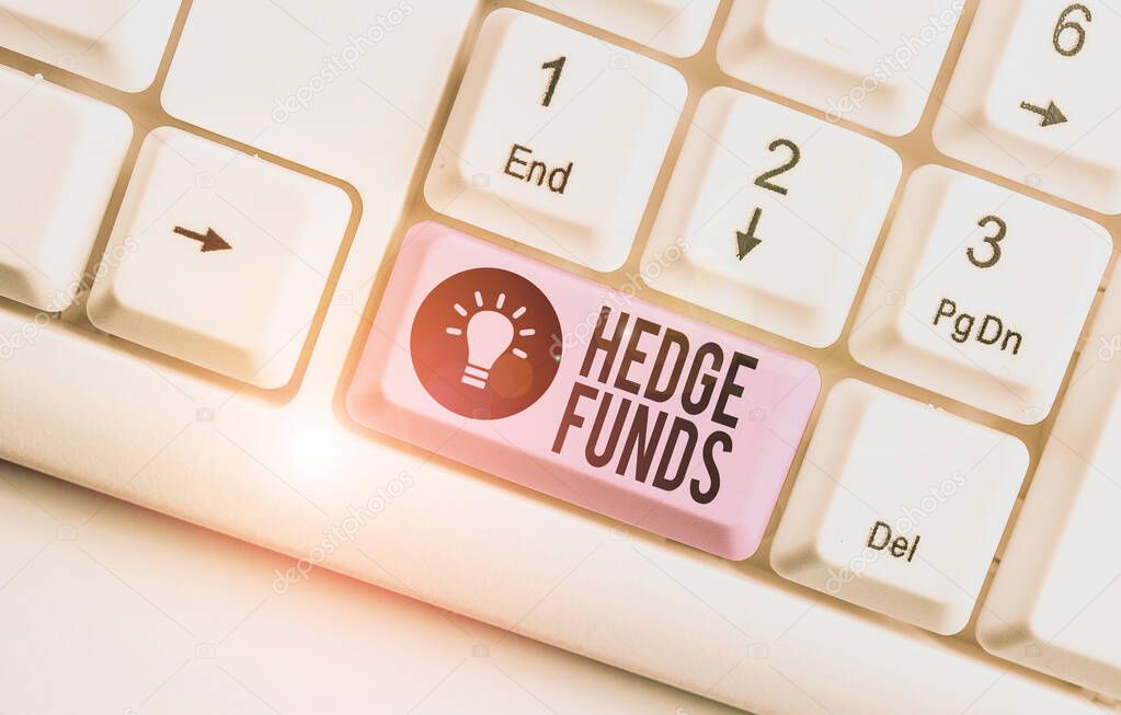 Writing note showing Hedge Funds. Business photo showcasing basically a fancy name for an alternative investment partnership White pc keyboard with note paper above the white background.
