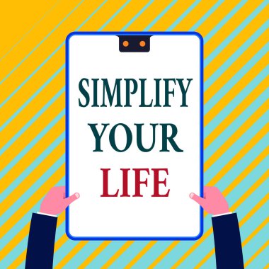 Writing note showing Simplify Your Life. Business photo showcasing Manage your day work Take the easy way Organize White rectangle clipboard with blue frame has two holes holds by hands.
