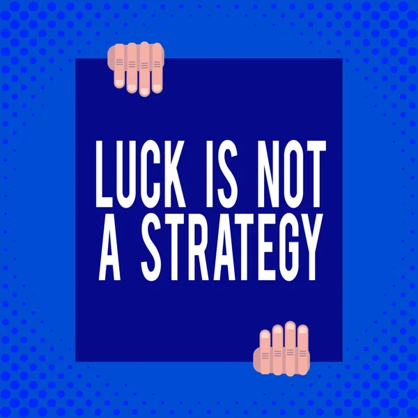 Word writing text Luck Is Not A Strategy. Business concept for it is not being Lucky when planned intentionally Two hands holding big blank rectangle up down Geometrical background design.