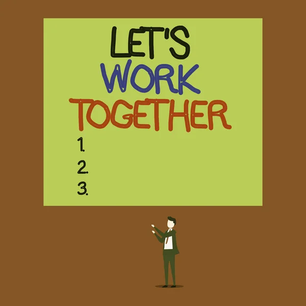 Написання тексту Let S Work Together. Концепція означає "Об'єднувати та об'єднувати сили, щоб досягти спільної мети". Молодий чоловік стоїть, показуючи вгору два великих прямокутника.. — стокове фото