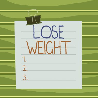 Conceptual hand writing showing Lose Weight. Business photo showcasing the fact of a demonstrating s is or an animal s is body weight becoming less Paper lines binder clip suare notebook color backgro