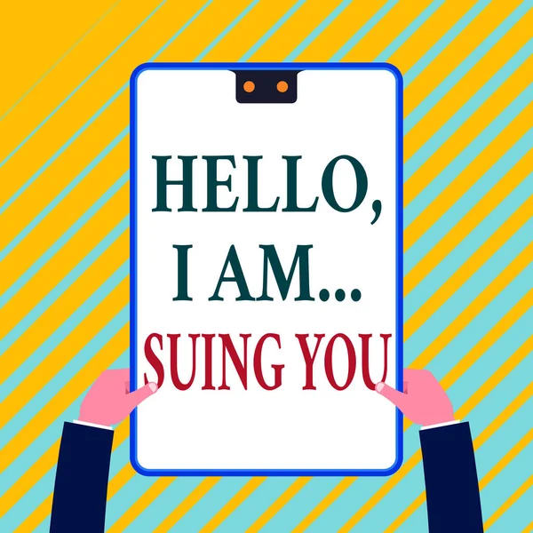 Writing note showing Hello I Am Suing You. Business photo showcasing create a case to accuse someone from his actions White rectangle clipboard with blue frame has two holes holds by hands.