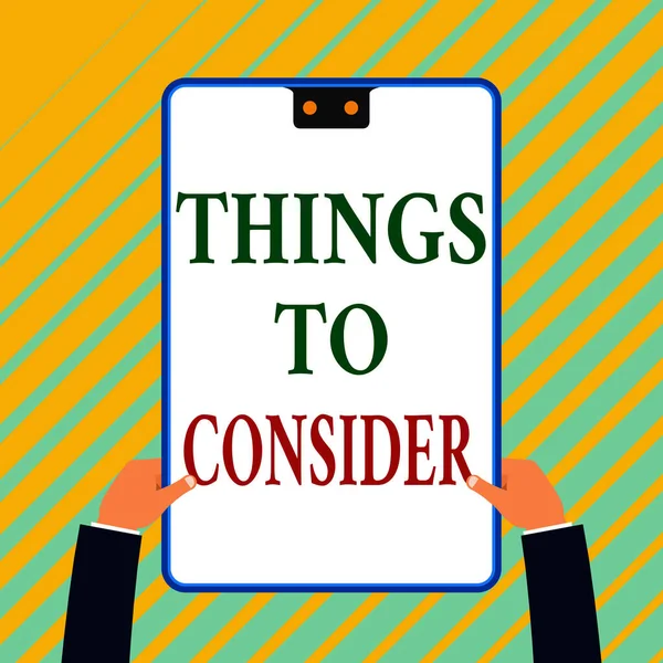 Writing note showing Things To Consider. Business photo showcasing list to check or do it Shopping Schedule Time table White rectangle clipboard with blue frame has two holes holds by hands. — Stockfoto