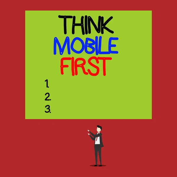 Handwriting text Think Mobile First. Concept meaning Easy Handheld Device Accessible Contents 24 or7 Handy Isolated view young man standing pointing upwards two hands big rectangle.