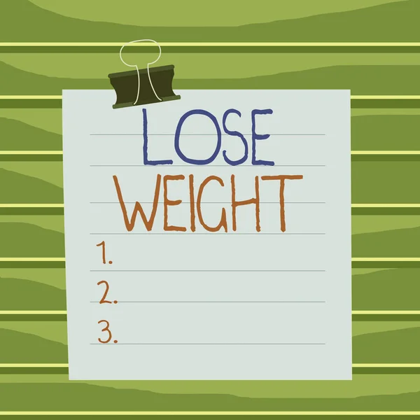 Conceptual hand writing showing Lose Weight. Business photo showcasing the fact of a demonstrating s is or an animal s is body weight becoming less Paper lines binder clip suare notebook color backgro — Stockfoto