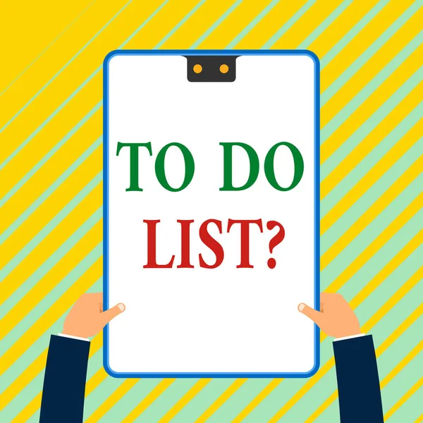 Writing note showing To Do List Question. Business photo showcasing Series of task to be done organized in priority order White rectangle clipboard with blue frame has two holes holds by hands.