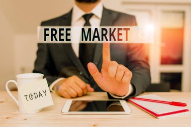 Text sign showing Free Market. Conceptual photo an unregulated system of economic exchange or free competition Male human wear formal clothes present presentation use hi tech smartphone.