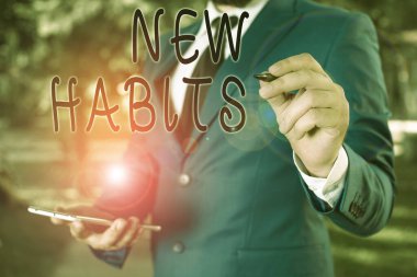 Conceptual hand writing showing New Habits. Business photo text change the routine of behavior that is repeated regularly Businessman holds laptop and pen pointing into the copy space. clipart