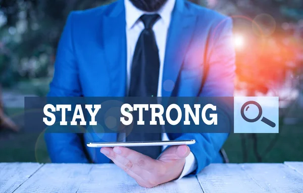 Word writing text Stay Strong. Business concept for have a clarity and never give up with what you want out of life Businessman with mobile phone in his hand.