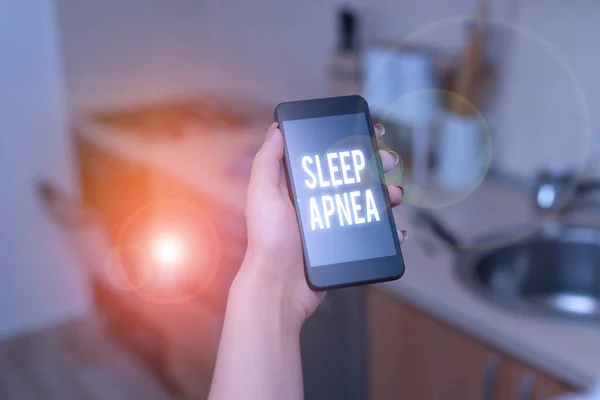 Conceptual hand writing showing Sleep Apnea. Business photo text disorder which demonstrating repeatedly stop breathing when asleep woman using smartphone and technological devices inside the home.