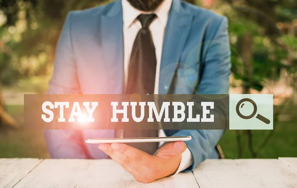 Word writing text Stay Humble. Business concept for not proud or arrogant Modest to be humble although successful Businessman with mobile phone in his hand.