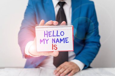 Conceptual hand writing showing Hello My Name Is. Business photo text introducing yourself to new showing workers as Presentation Man holds empty paper with copy space in front of him Space.