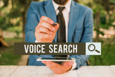 Handwriting text Voice Search. Concept meaning allows the user to use a voice comanalysisd to search the Internet Businessman pointing with pen in empty copy space.