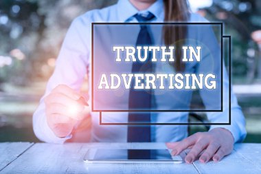 Text sign showing Truth In Advertising. Conceptual photo Practice Honest Advertisement Publicity Propaganda Female business person sitting by table and holding mobile phone.
