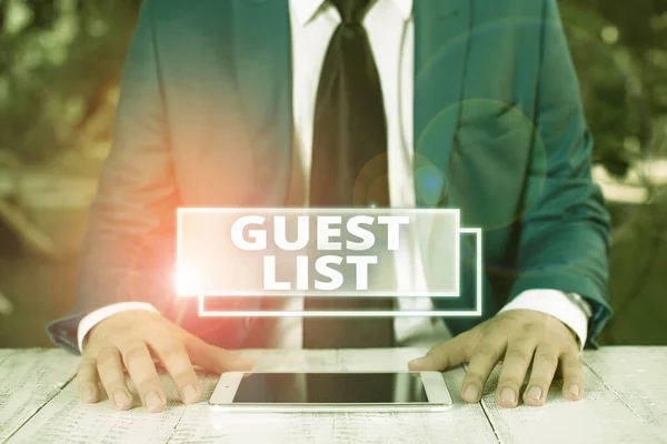 Writing note showing Guest List. Business photo showcasing a list of showing who are allowed to enter the show or an event Businessman in blue suite with a tie holds lap top in hands.
