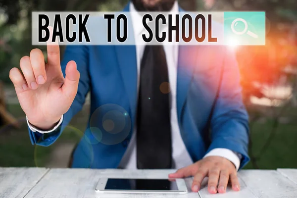 Conceptual hand writing showing Back To School. Business photo showcasing New Teachers Friends Books Uniforms Promotion Tuition Fee Businessman with pointing finger in front of him.