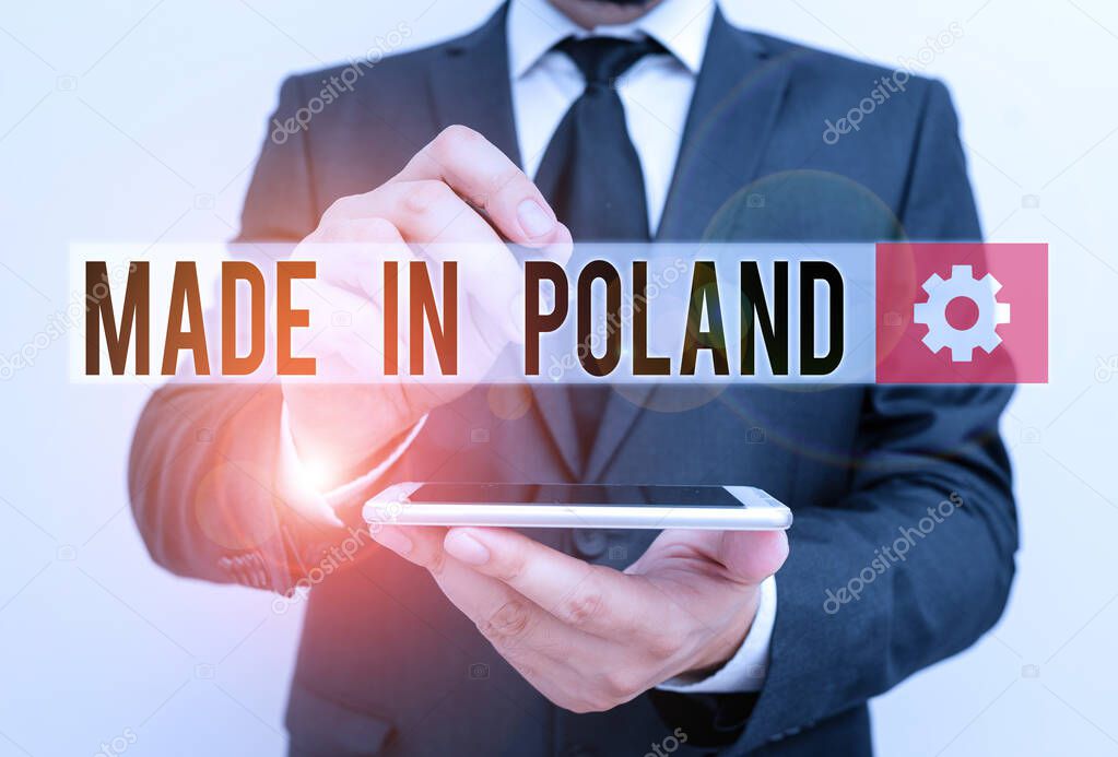 Text sign showing Made In Poland. Conceptual photo A product or something that is analysisufactured in Poland Male human wear formal work suit hold smart hi tech smartphone use one hand.