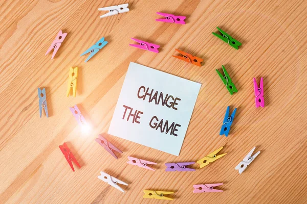 Writing note showing Change The Game. Business photo showcasing Make a movement do something different new strategies Colored clothespin papers empty reminder wooden floor background office.